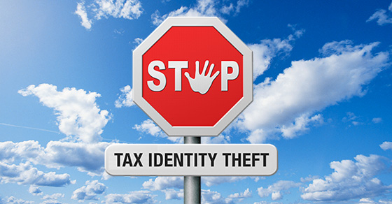 Image of a stop sign with a hand print as the "o". Under the stop sign is a sign that reads tax identity theft.